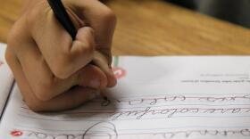 A student practices writing in cursive. (Jae C. Hong/AP)