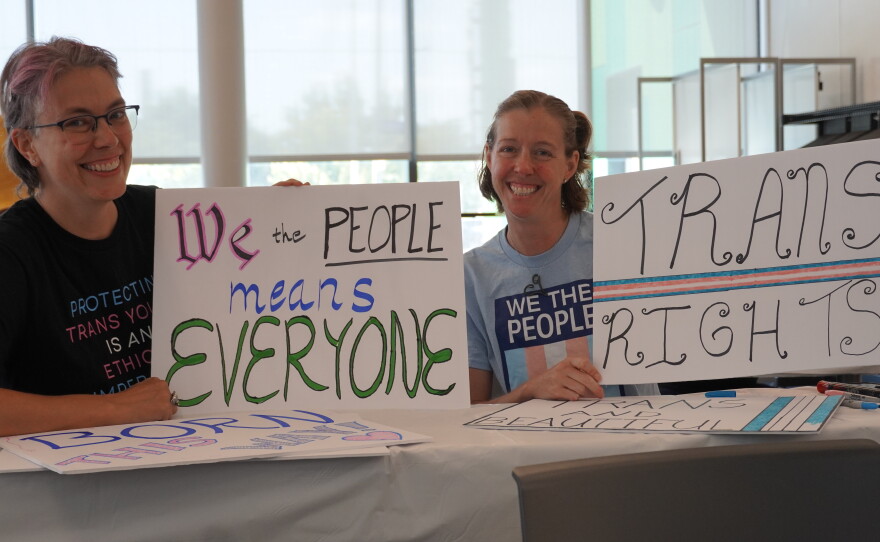 Images of supporters holding signs that they made for the protest.