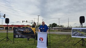 Elkhart Director of Public Works Jeffrey Schaffer discusses the Hively Avenue overpass project as Amtrak's Lake Shore Limited passes in the background.