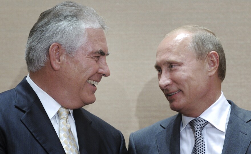 Russian leader Vladimir Putin (right), and Rex Tillerson, the head of ExxonMobil, smile during a signing ceremony for an oil agreement in Sochi, Russia, in 2011. Tillerson is widely reported to be President-elect Donald Trump's favored choice for secretary of state. U.S. policy toward Moscow used to be a unifying issue among Republicans and Democrats, but now it's a source of division.