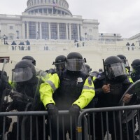 Law enforcement, including Capitol Police officers, try to hold back rioters at the Capitol on Jan. 6.