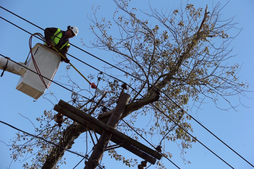 Crews work to restore power in Bethpage, N.Y., on Saturday. As of Wednesday, more than 200,000 Long Island residents were still without power, as a nor'easter made new outages likely.