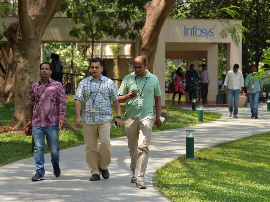 Employees of Infosys Technologies walk on the campus of the company's headquarters in Bangalore, India, on April 13.