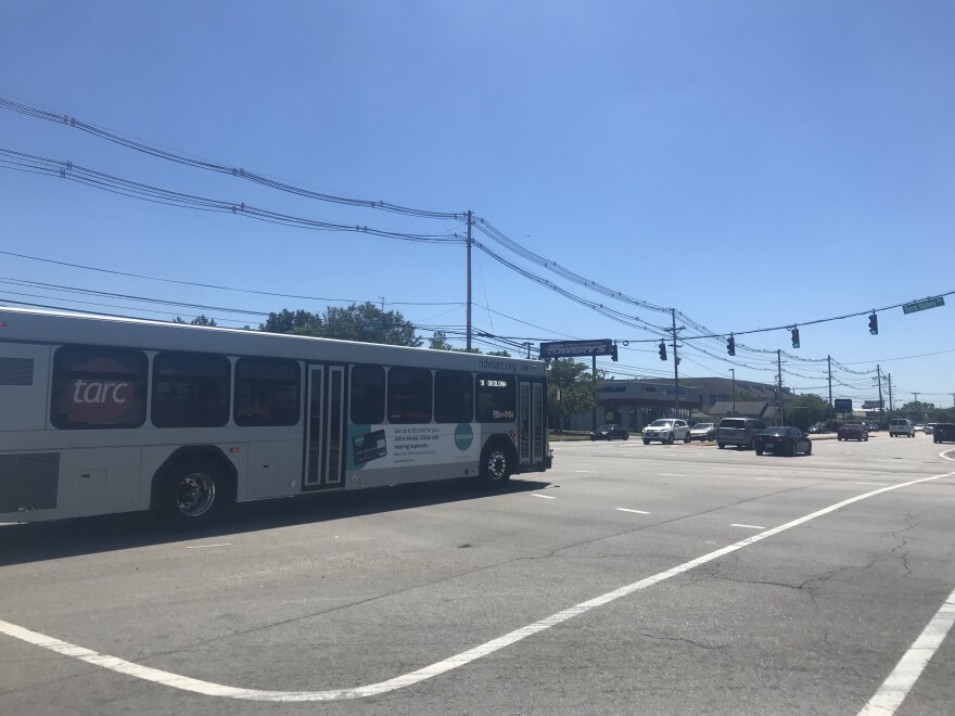 A TARC bus drives across an intersection along the Preston corridor. 