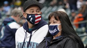 Fans wear baseball-themed face masks at a Mariners game April 1, 2021, at T-Mobile Park in Seattle.