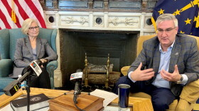 Indiana Health Commissioner Dr. Kris Box, left, and Gov. Eric Holcomb discuss the state's response to COVID-19.