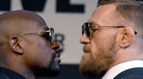 Boxer Floyd Mayweather Jr. (left) and UFC lightweight champion Conor McGregor face off during a news conference at the KA Theatre at MGM Grand Hotel & Casino on Aug. 23, 2017 in Las Vegas, Nevada. (Ethan Miller/Getty Images)