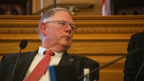 Kansas House Speaker Dan Hawkins, a Republican, leans over to speak to a colleague during a special legislative session on taxes in June 2024. 