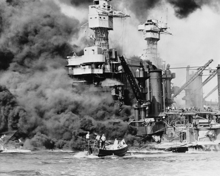 A small boat rescues a seaman from the 31,800 ton battleship USS West Virginia on Dec. 7, 1941.