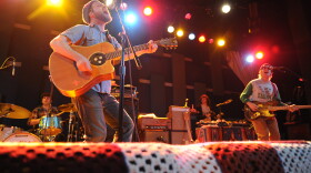 Toby Leaman (left, front) picks up an acoustic guitar while performing with Dr. Dog.
