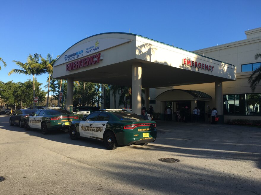 Police patrol the hospital on Feb. 14 as staff members were treating shooting victims.