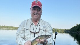 Hanover Delegate Buddy Fowler, author of the bill to expand free fishing days, holds a fish he's caught. 