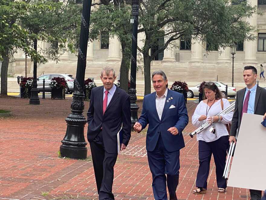 Massachusetts Secretary of State Bill Galvin (left) and Springfield Mayor Domenic Sarno in Springfield walk to a press conference. 