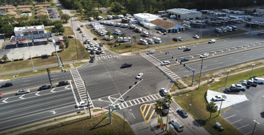 Four Way intersection with a top-down view, with a few businesses on the corners