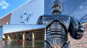 A statue of the movie character robocop, with an inset photo of a brutalist building.