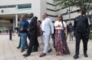 Attorney Ben Crump, second from left, walks with Ron Lacks, left, Alfred Lacks Carter, third from left, both grandsons of Henrietta Lacks, and other descendants of Lacks, outside the federal courthouse in Baltimore, Oct. 4, 2021.