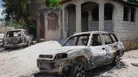 FILE - Vehicles that were set on fire by armed gangs sit in the Cite Soleil neighborhood of Port-au-Prince, Haiti, May 12, 2026.