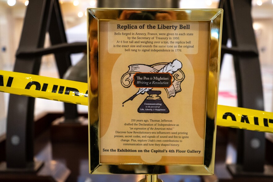 The sign on a stanchion in front of the bell replica explains when the artifact was gifted, April 29, 2026.