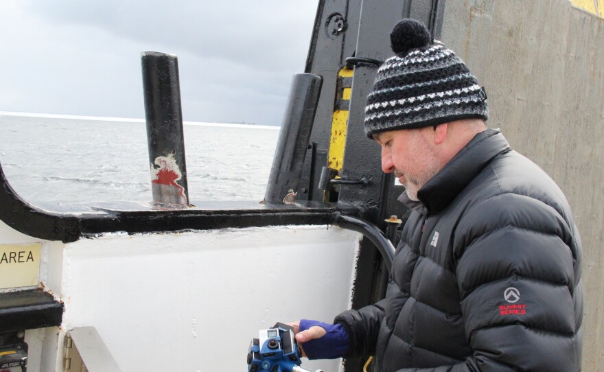 Videographer Jason Lopez sets up his 360 camera aboard a Washington Island Ferry