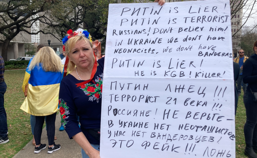 Lana, a native of Kyiv, Ukraine, holding a poster ridiculing Russian President Vladimir Putin