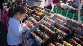 Brittany Huysmans, 6, inspects a bracelet display at the Central Flea Market's new location on Galleria Boulevard on Saturday, Nov. 11, 2022.