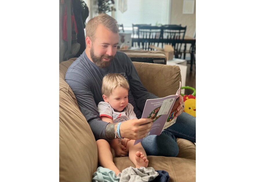 Nathan Alder reads to his son, Bjorn. Bjorn was an Imagination Library book recipient, and his parents say reading together allowed them to connect with him.