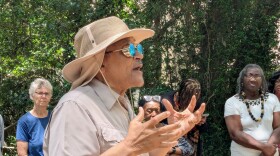 Tallahassee historian Dr. Larry Rivers speaks to the visitors at the Betton Hills cemetery.