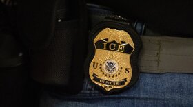 FILE - A federal agent wears an Immigration and Customs Enforcement badge in New York, June 10, 2025. (AP Photo/Yuki Iwamura, File)