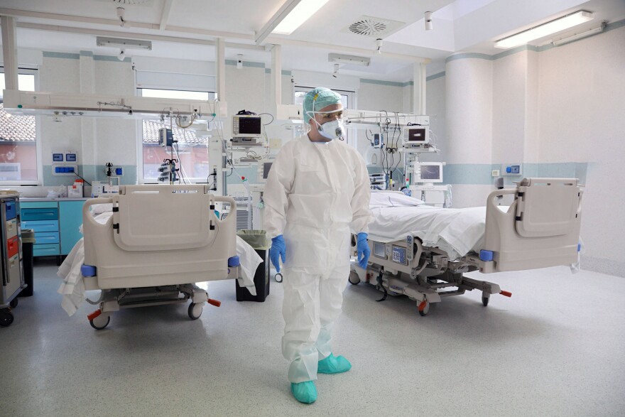 Nurse prepares hospital beds in covid ward