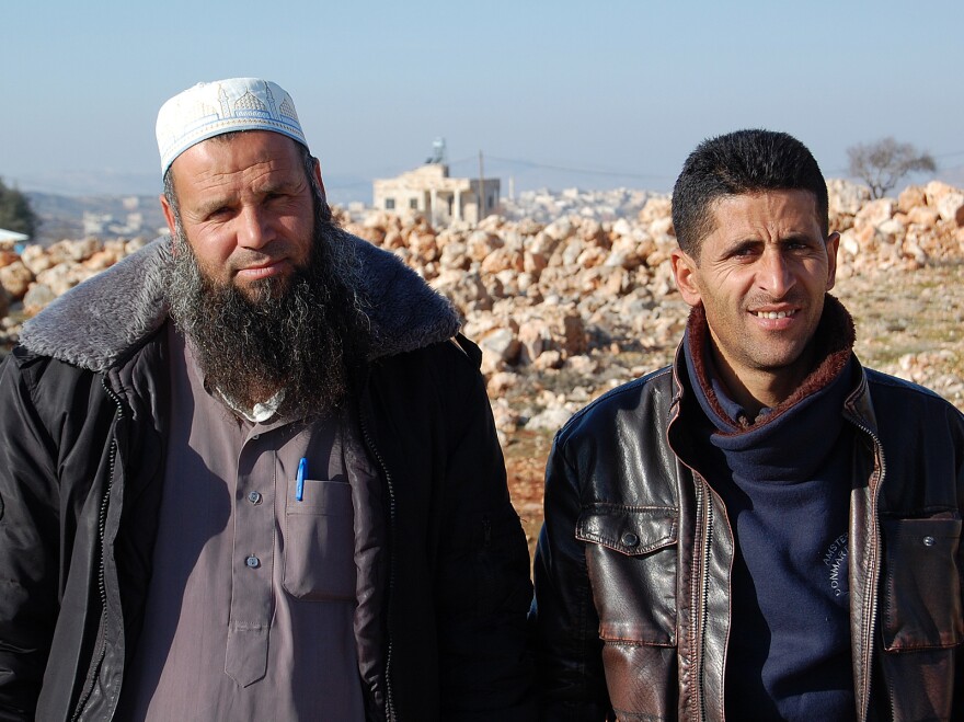 Ziad Oday (left), a village council member and imam in Qusra, and Abdel Wadi, Qusra village council head, intervened in the recent clash between Jewish settlers and angry Palestinians. They're shown here on a hill in Qusra.