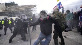 Trump supporters try to break through a police barrier, Wednesday, Jan. 6, 2021, at the Capitol in Washington. As Congress prepares to affirm President-elect Joe Biden's victory, thousands of people have gathered to show their support for President Donald Trump and his claims of election fraud. (AP Photo/Julio Cortez)