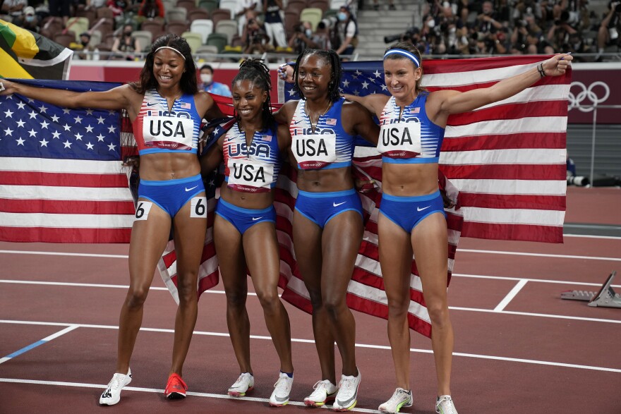 Team United States celebrates winning the silver medal in the final of the women's 4 x 100-meter relay at the 2020 Summer Olympics, Friday, Aug. 6, 2021, in Tokyo.(AP Photo/David J. Phillip)