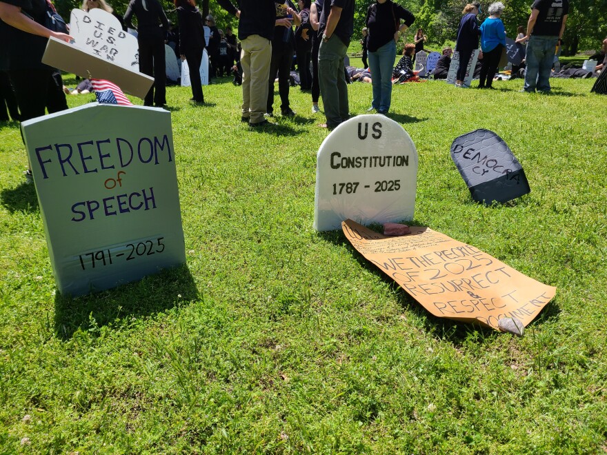 Mock gravestones symbolizing the death of democratic institutions at a protest at Woodward Park in Tulsa on May 3, 2025.