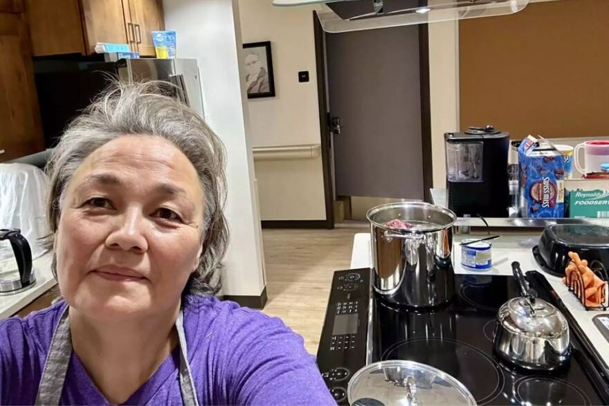 a woman takes a selfie in a kitchen