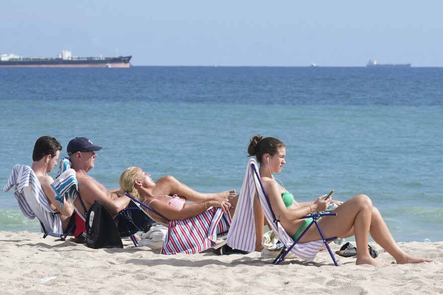 Beachgoers face the sun on Fort Lauderdale beach, Thursday, Dec. 22, 2022. South Florida attracted the highest amount of individual income moving from 2020 to 2021.