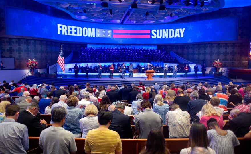 Churchgoers bow their heads in prayer during the Freedom Sunday sermon at First Baptist Dallas June 26. The congregation celebrated both Independence Day and the Supreme Court's decision to oveturn Roe v. Wade.