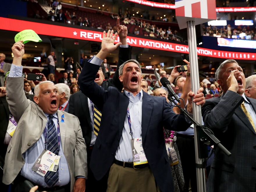 Former Virginia Attorney General Ken Cuccinelli (left) along with other delegates from Virginia chant for a rule call vote on the first day of the Republican National Convention on Monday at the Quicken Loans Arena in Cleveland, Ohio.