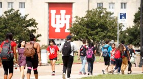 Students walk outside on the campus of the University of Houston.