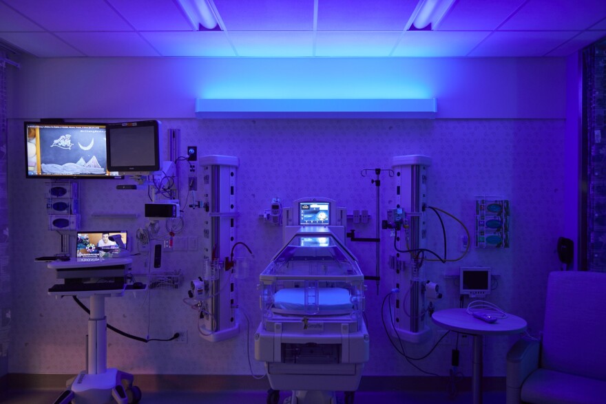 a hospital room illuminated with blue light