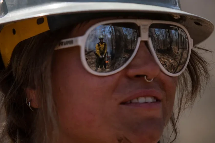 Fellow Piper Morris looks on at Izaiah Lees while the two, both with The Nature Conservancy, wait for a unit to burn March 25, 2026, in Makanda, Illinois.