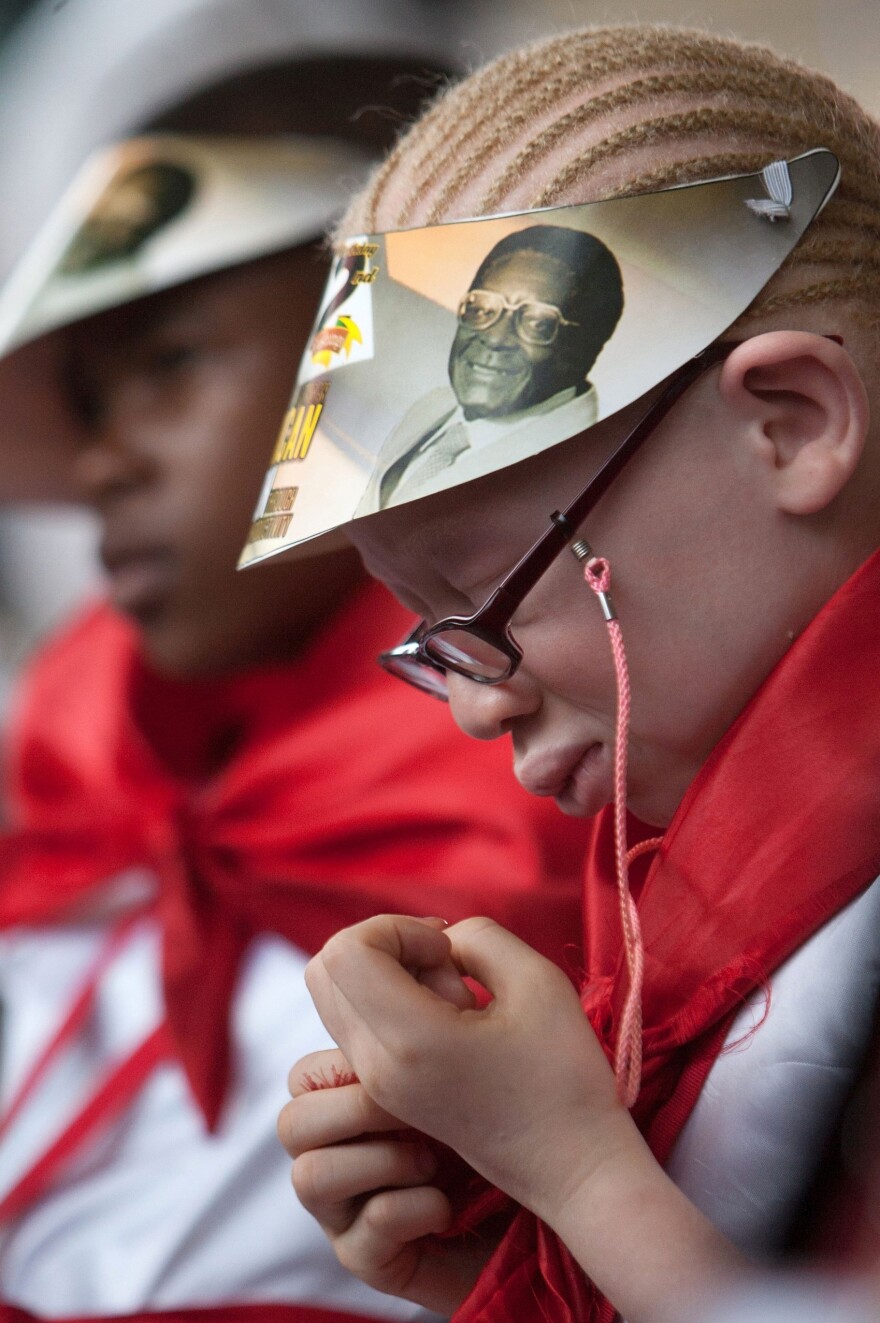 A girl listens to a speech by Mugabe during celebrations marking his birthday at the Great Zimbabwe monument in Masvingo on Saturday.