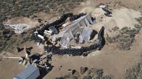 A compound is seen in the desert area of Amalia, N.M., on Aug. 10, 2018. Two firearms charges were dismissed Thursday, Sept. 21, 2023, amid preparations for trial against an extended family arrested in a 2018 law enforcement raid on the compound in northern New Mexico and the discovery of a young boy's decomposed body. 