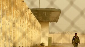 An Iraqi security officer patrols the grounds at Baghdad Central Prison in Abu Ghraib in 2009.