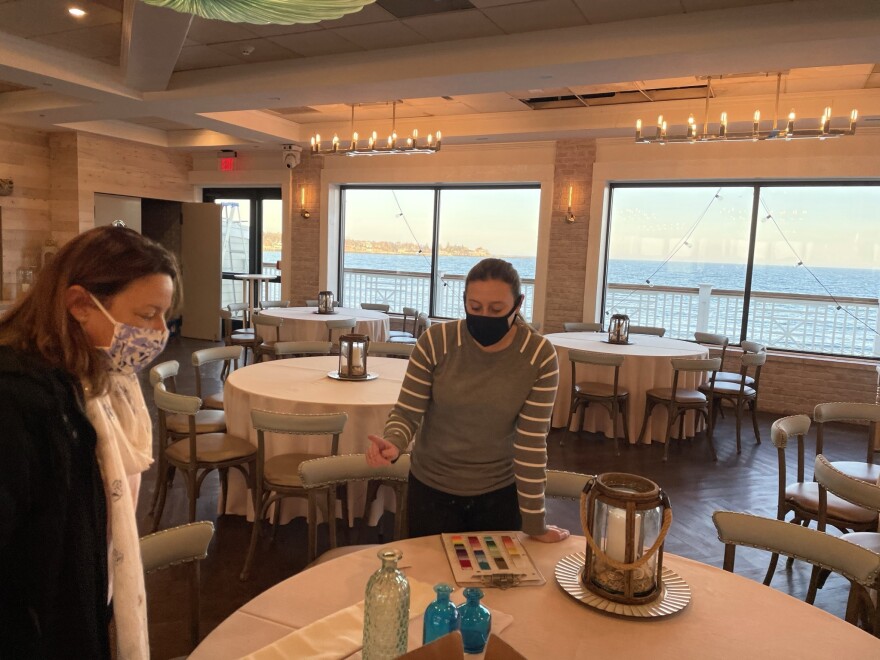 Soon-to-be bride Tricia Henderson (left) scrutinizes napkin colors with Allison Loomis of Oceanview of Nahant.