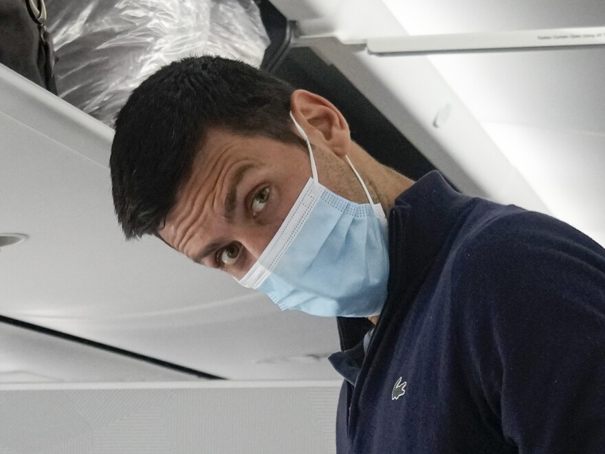 Novak Djokovic prepares to take his seat on a plane to Belgrade, in Dubai, United Arab Emirates, Monday, Jan. 17, 2022.