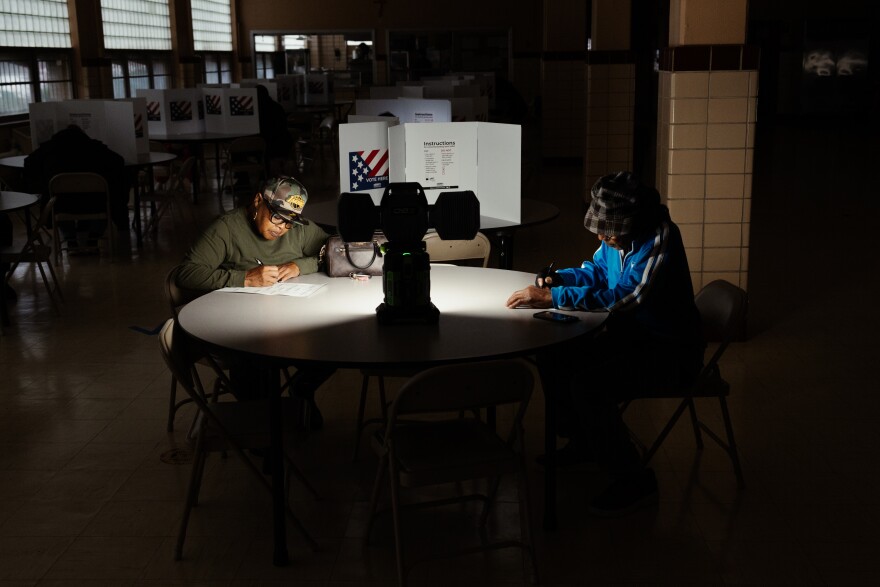 Voters take to the polls during the General Election on Tuesday, Nov. 5, 2024, at Holy Name Community Center in Bellefontaine Neighbors, Mo. A power outage at the polling site caused staff to run off of lanterns and generators.