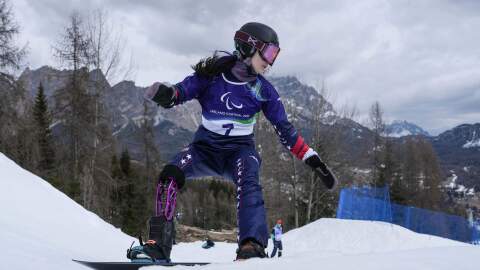 Brenna Huckaby of the United States rides during Women's Banked Slalom Para Snowboard training at the 2026 Winter Paralympics in Cortina d'Ampezzo, Italy, Thursday, March 12, 2026.