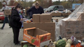Pantry 279 director Cindy Chavez (masked, purple shirt) checks some last-minute details before food distribution begins.