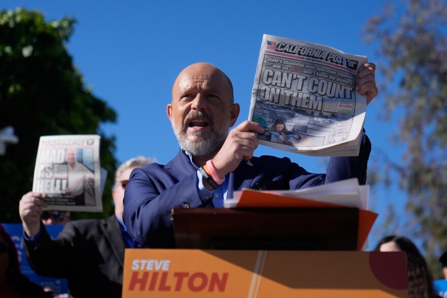 California Republican gubernatorial candidate Steve Hilton holds a newspaper while speaking at a news conference at the San Mateo County elections office Friday, June 5, 2026, in San Mateo, Calif.