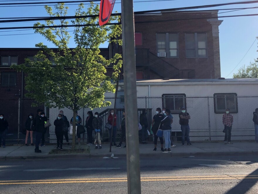 Workers wait for their ride outside On Target, a temp agency in New Brunswick, on a Monday morning in June.